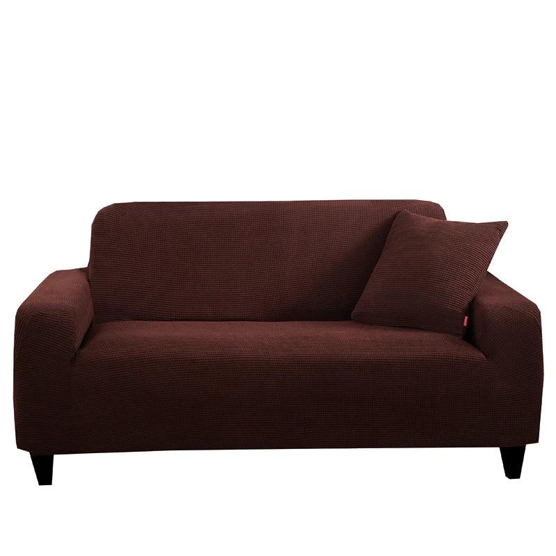 Housse de canapé Cléa en coton extensible, moderne et durable marron foncé.