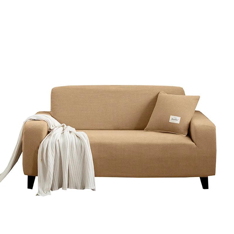 Housse de canapé Cléa en coton extensible, moderne et durable marron.